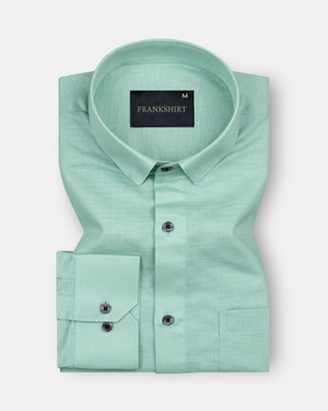 A green, long-sleeved, button-down linen shirt with a chest pocket on the left side.