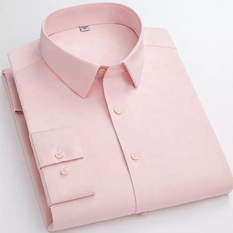 A pink cotton shirt with full sleeves and a collar, displayed on a stack.