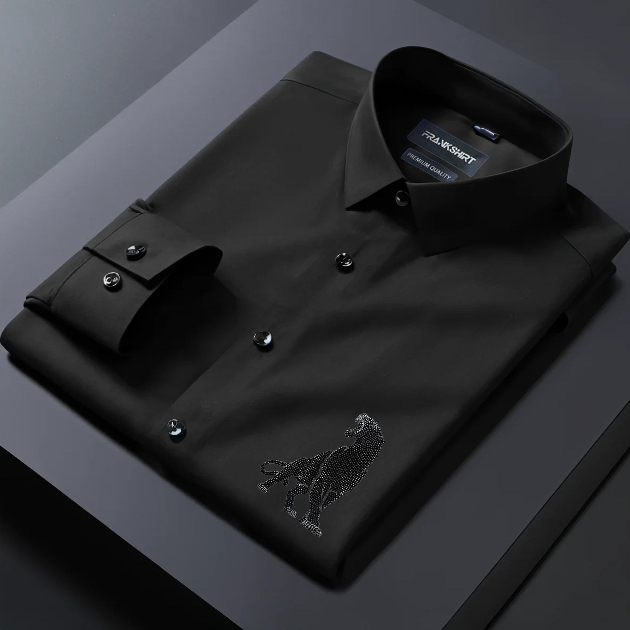 Black dress shirt with an eagle emblem on a dark surface