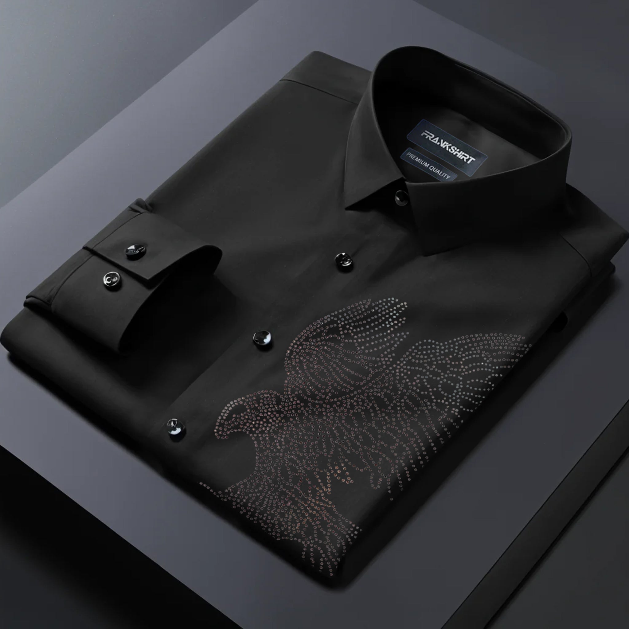 Black dress shirt with an eagle design on a dark surface