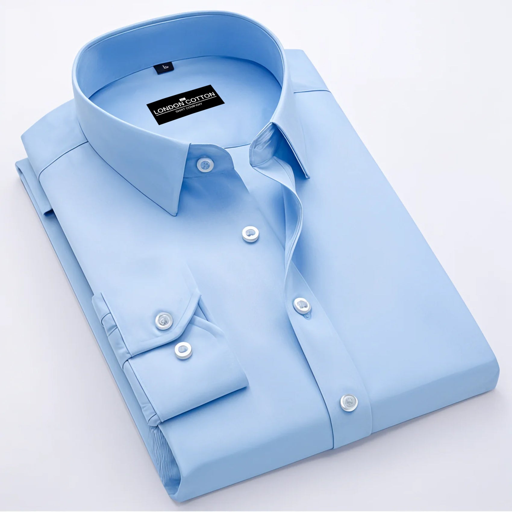 Light blue dress shirt with collar tag on a light gray background