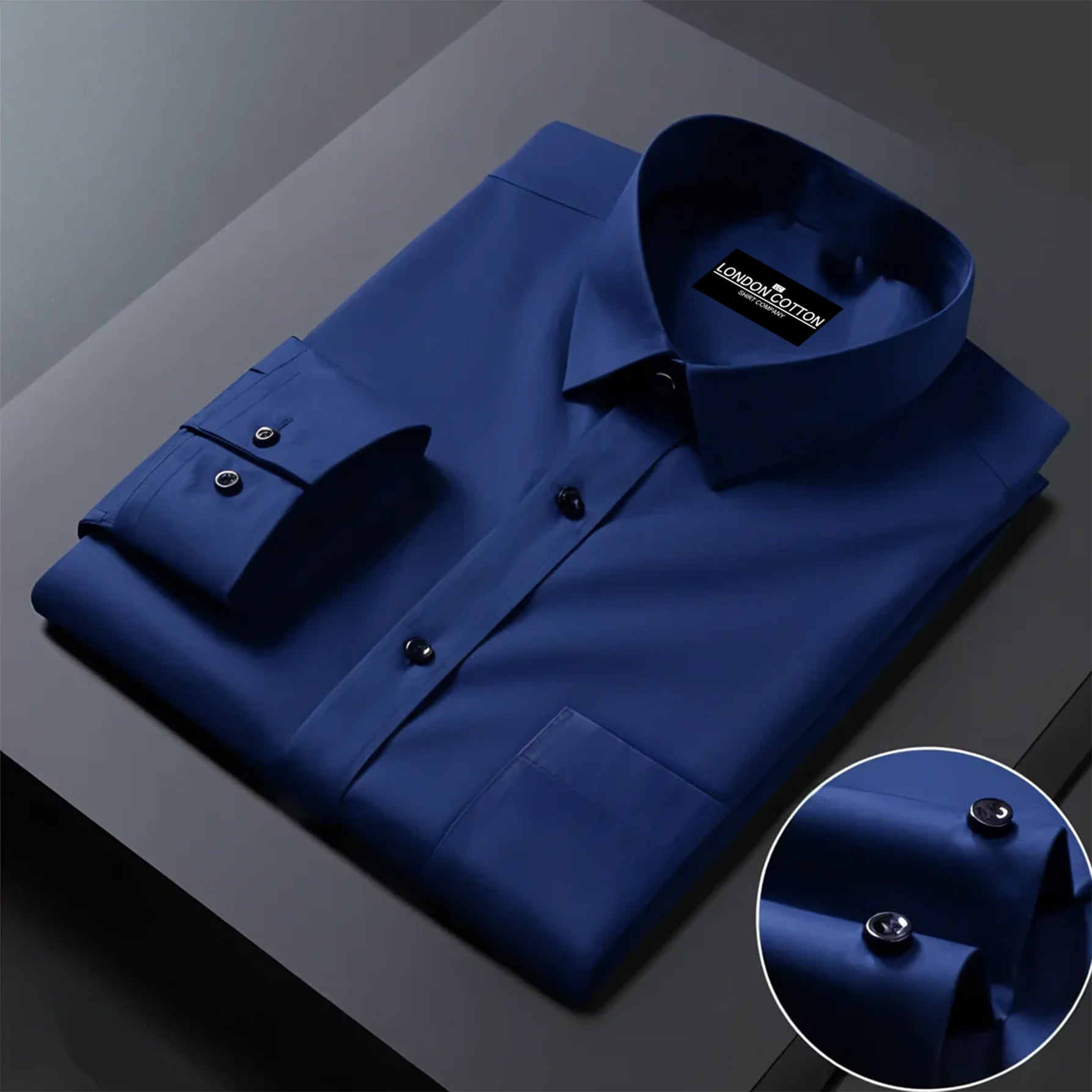 Folded blue shirt with a close-up of buttons on a dark surface