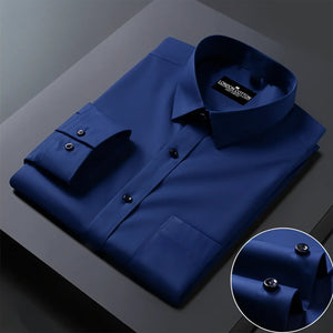 Folded blue shirt with a close-up of buttons on a dark surface