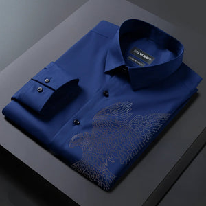 Folded blue shirt with a detailed design on a dark surface