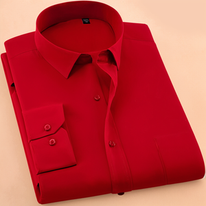 A folded red colored cotton shirt with long sleeves and a collar.