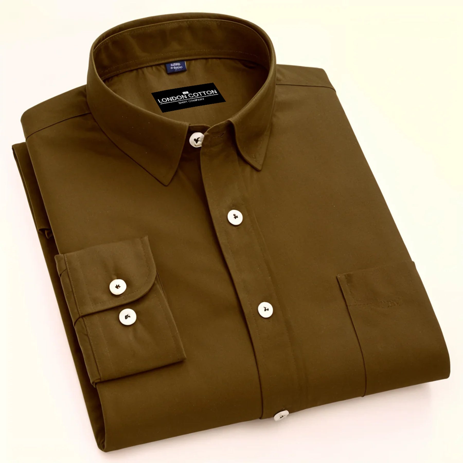 Folded brown shirt with 'London Cotton' label on a white background