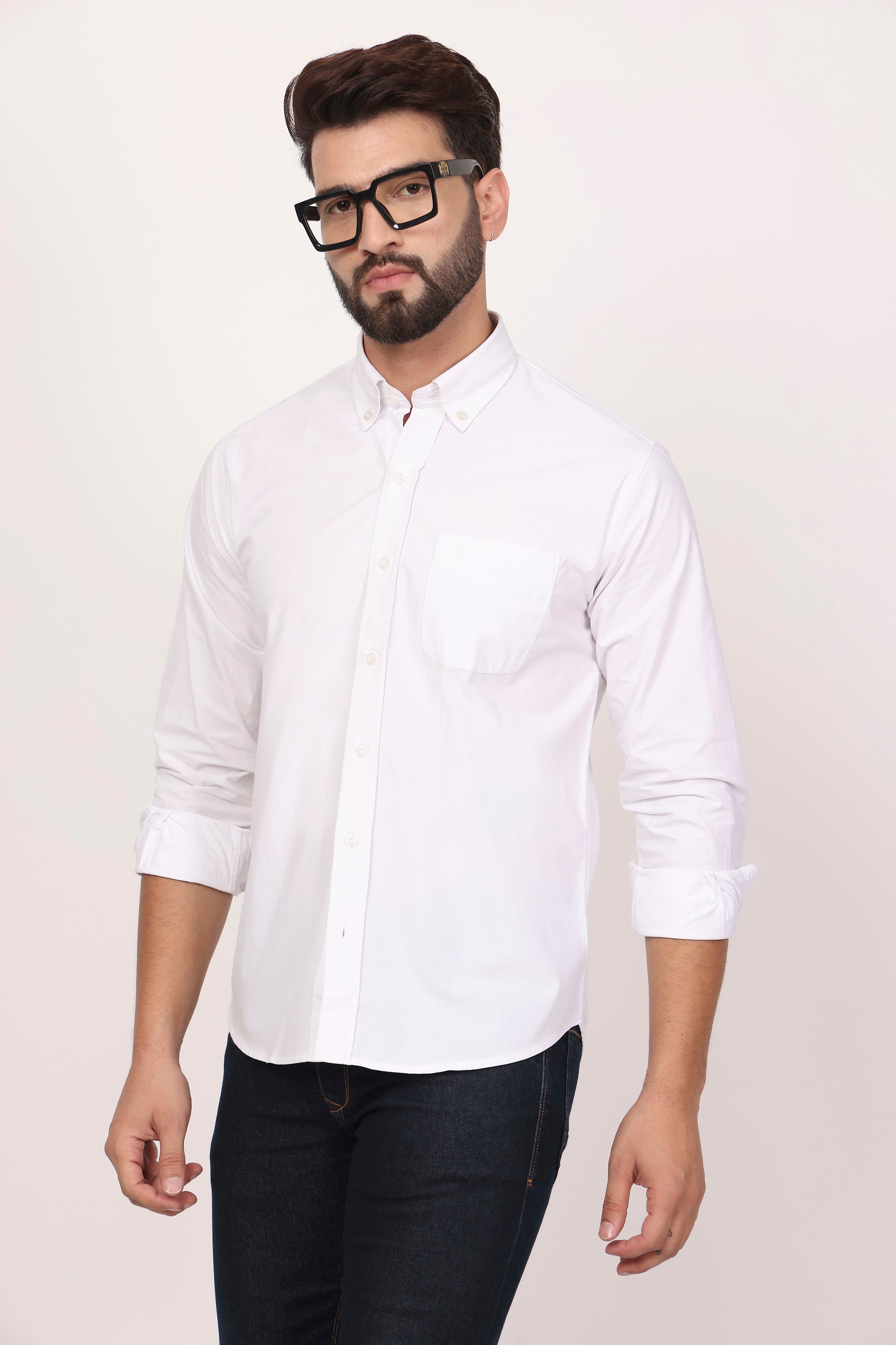 A male model wearing a white down button casual shirt with full sleeves, made of cotton twill fabric.