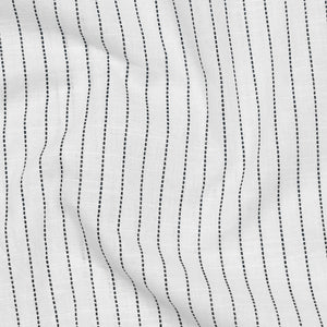 Close-up of white fabric with black parallel lines