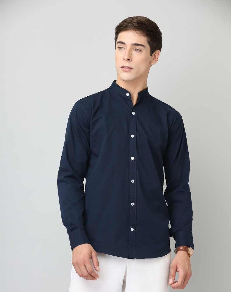 Man wearing a navy blue shirt with a white background