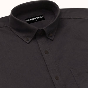 Close-up of a black shirt with a 'Premium Shirts' label on the collar.