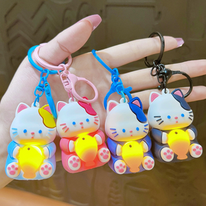 Four Different Coloured Lightup Cat Keychains with Yellow Lightning Fish Held by a Hand - Tinyminymo