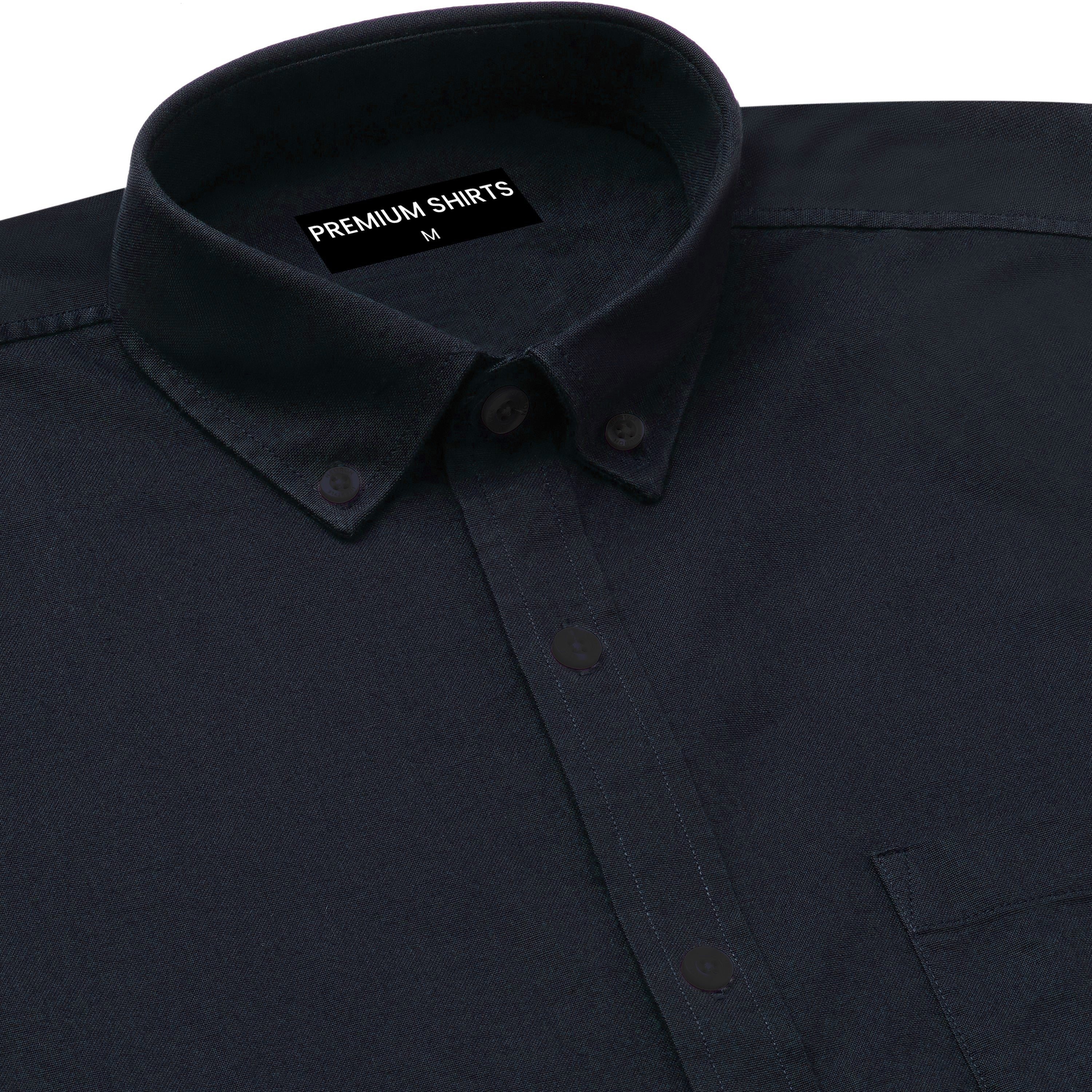 Close-up of a dark blue shirt with a collar and label on a white background