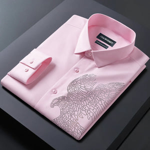 Pink dress shirt with decorative angel wings on a dark surface