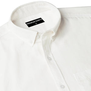 Close-up of a white shirt with a 'Premium Shirts' label on a white background